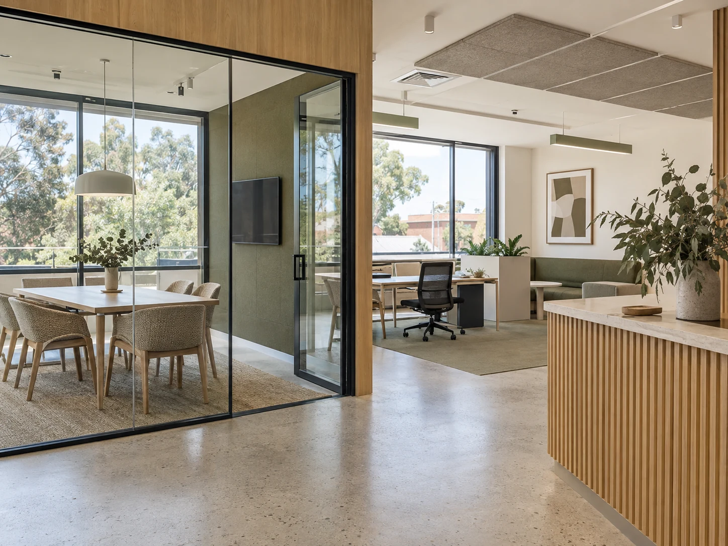 A fictional workplace fit-out with a glazed meeting room and open studio.